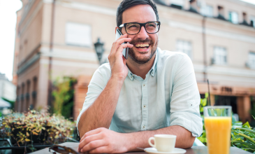 Man talking on phone laughing